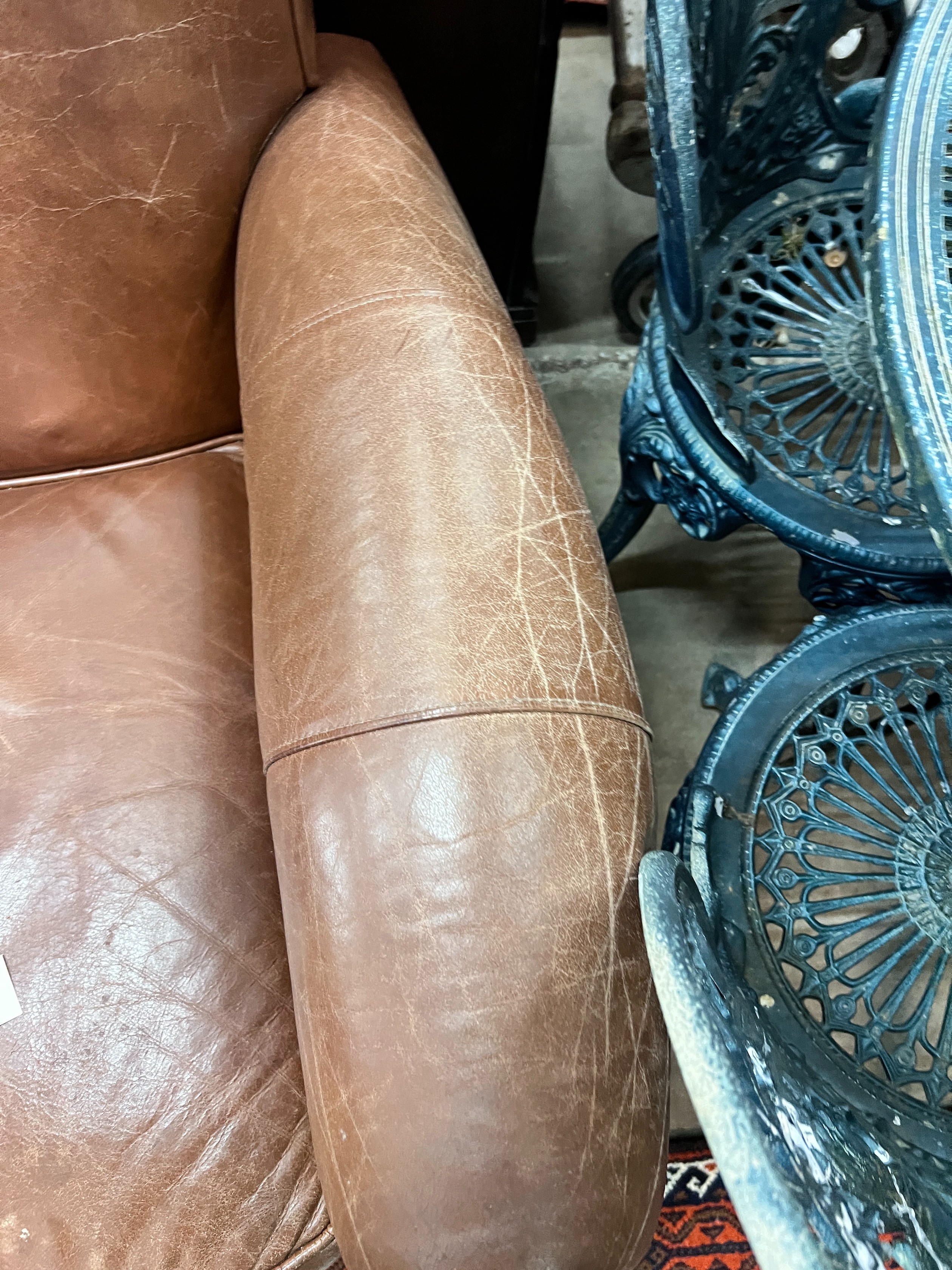 A contemporary tan leather reclining armchair with integral footrest, width 92cm, height 104cm *Please note the sale commences at 9am.